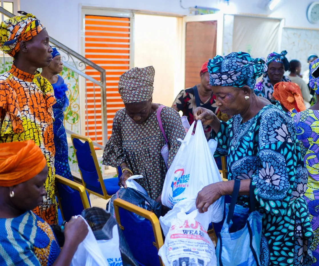 Widows look through the gifts they received at the Foundation&rsquo;s outreach in Akute.