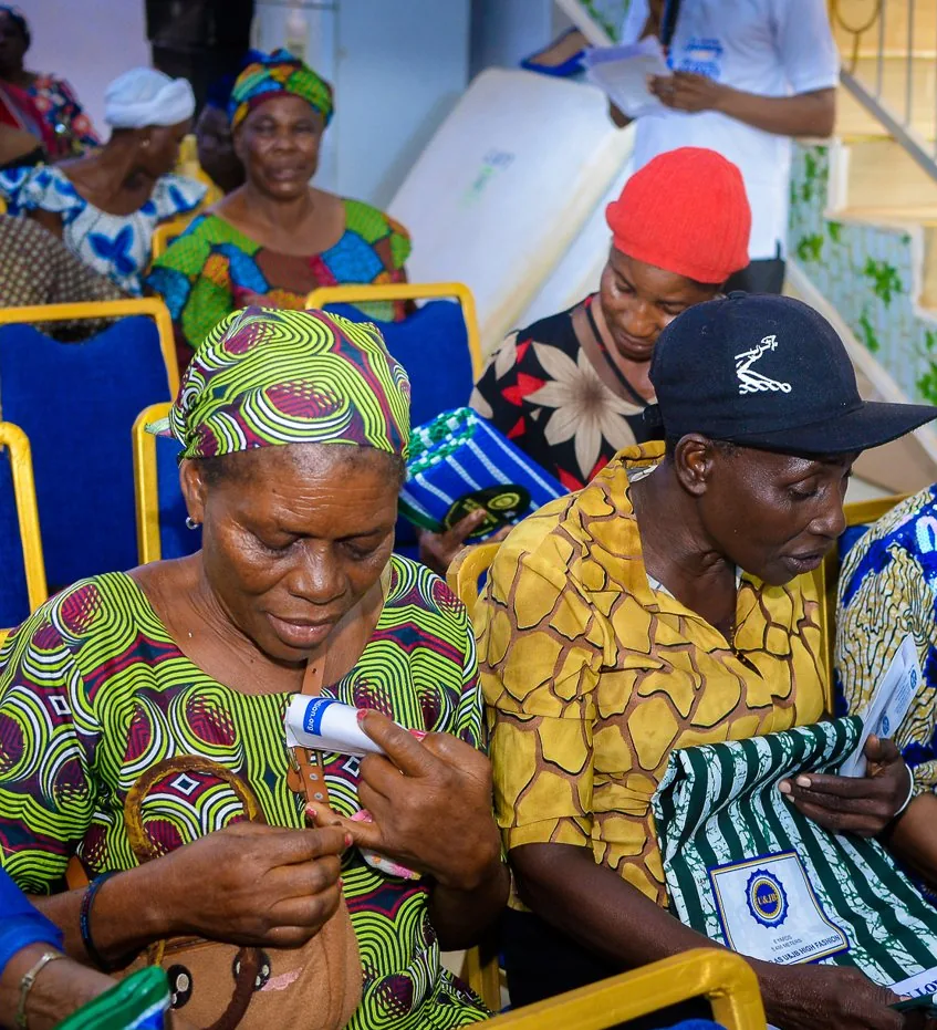 Women look through the gifts they received at the Foundation&rsquo;s outreach in Akute.