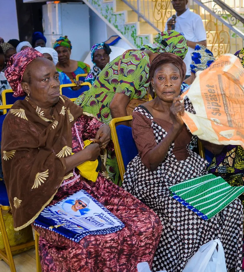 Two older women sit with the gifts they received at the Foundation&rsquo;s widows&rsquo; outreach in Akute.