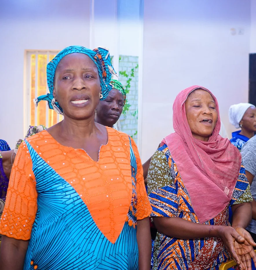 Women sing together at the Foundation’s widows’ outreach in Akute.
