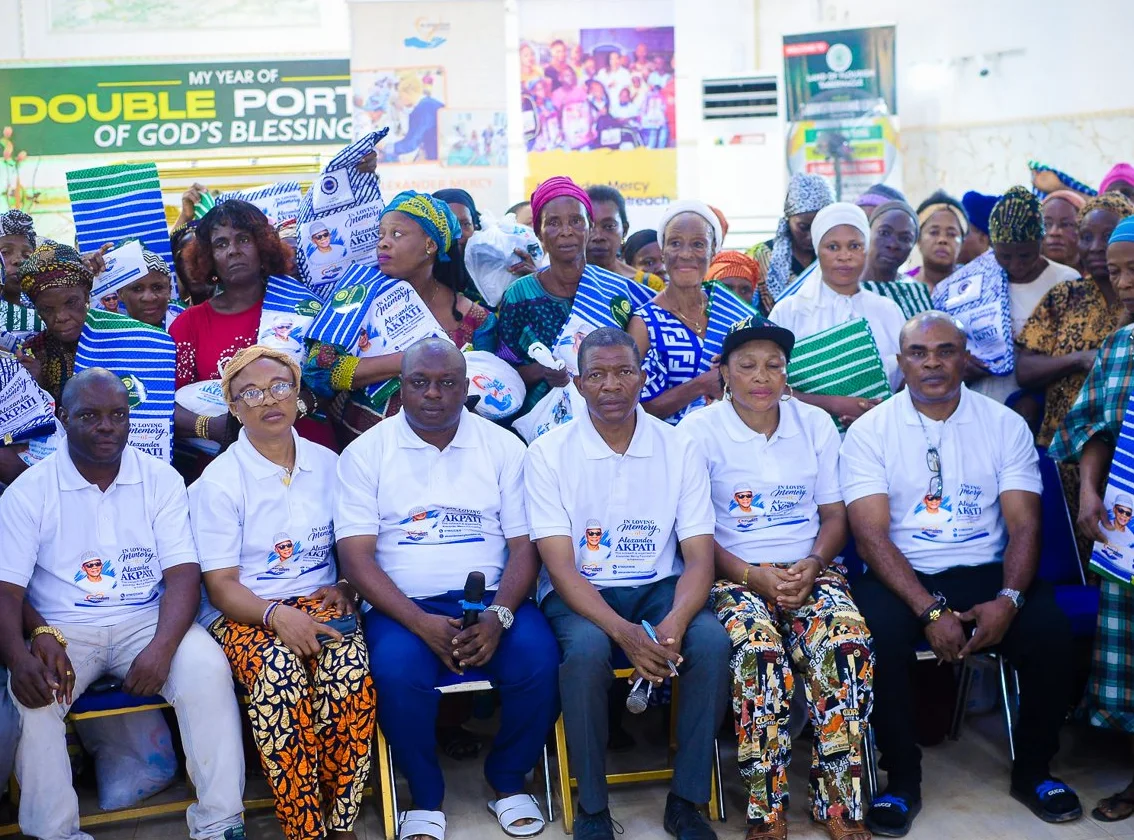 The Foundation team in white shirts with the widows at the outreach in Akute.
