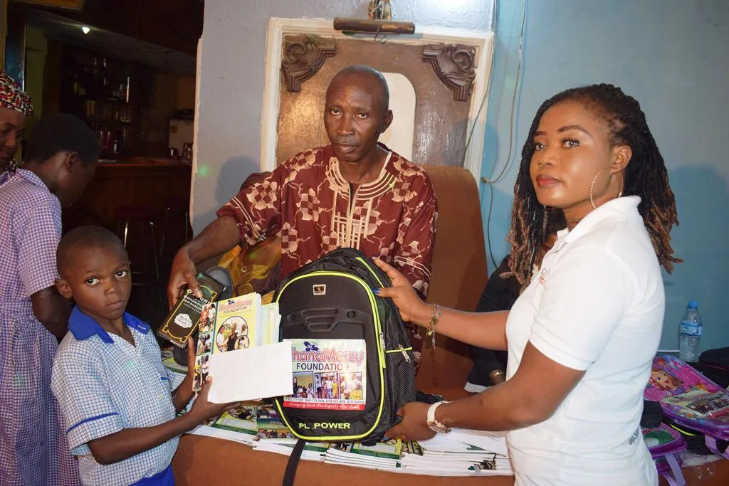 A schoolboy receiving a new school bag from the Foundation at a student scholarship event.