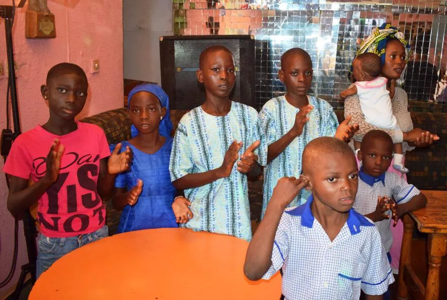 Children clapping at a student scholarship event.