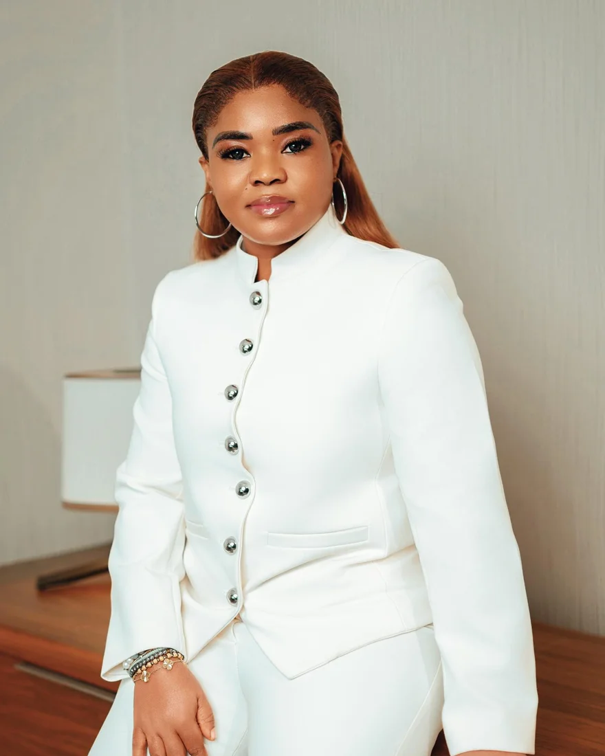 Mercy Alexander, founder of the Foundation, in a white suit.